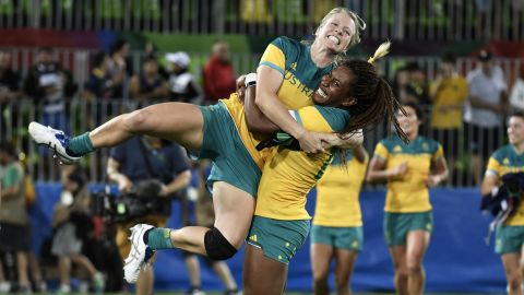 Australia's Ellia Green lifts up a teammate as they celebrate a gold medal win.