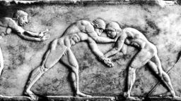 Two wrestlers compete in ancient Olympics. 