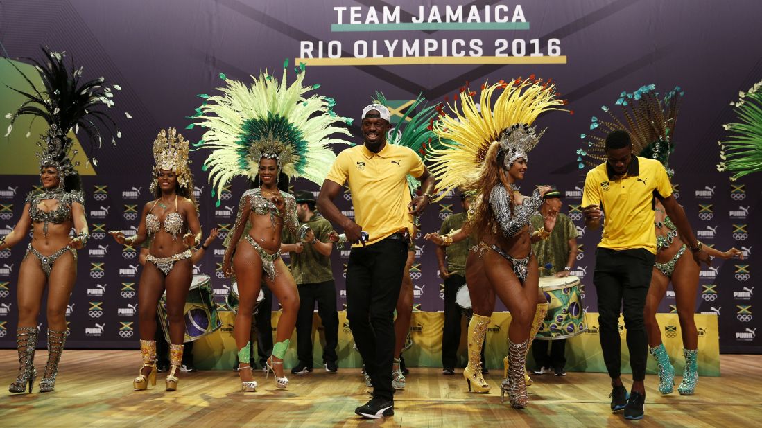Sprinter Usain Bolt, center, dances the samba during a news conference for Puma and the Jamaican Olympic Association. The world's fastest man will be defending his 100-meter title later in the Games.
