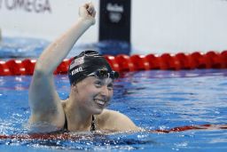Lilly King celebrates breaking the Olympic record in the Women's 100m Breaststroke