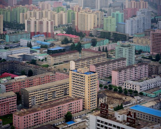 "A view of the capital's east seen from Juche Tower. Here the homogenous design of the city and absence of visual pollution from commercial advertising become apparent -- as well as the very linear and raw structures of most buildings."