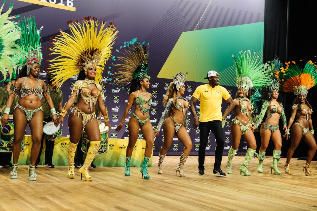 Usain Bolt struts his stuff with samba dancers in Rio.