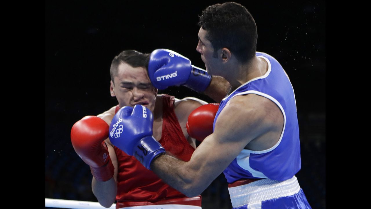 Mexico's Misael Uziel Rodriguez, left, takes a battering from Iraq's Waheed Abdulridha Waheed Karaawi during a middleweight boxing match. Rodriguez won the match, however, and advanced.