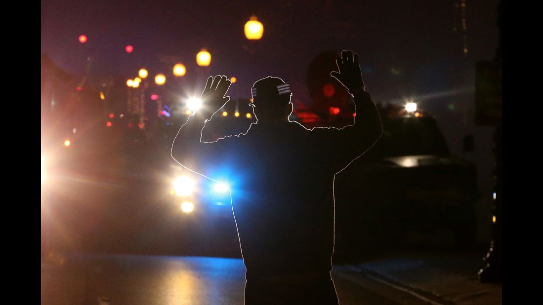 When 18-year-old Michael Brown was fatally shot by Darren Wilson in August 2014, it set off a chain reaction that led to protests nationwide. These images are some of the most iconic from that period, such as this photo of a protester who adopted the "hands up" stance seen in many demonstrations. It was used because some witnesses said that Brown had his hands up when he was killed. Click through the gallery for more images surrounding the protests.