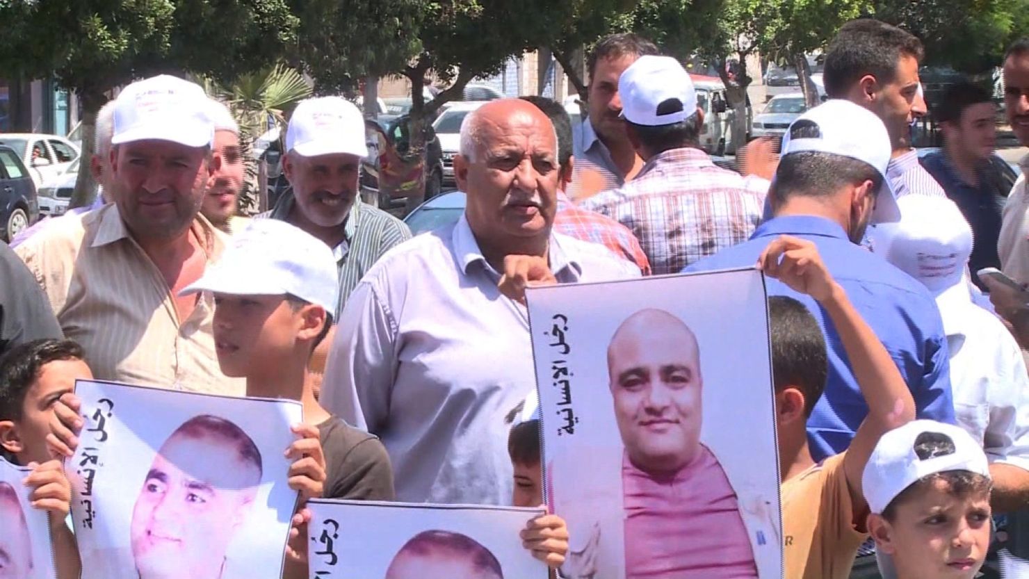Gaza residents protest the arrest of Mohammad El-Halabi, the Gaza director of World Vision.