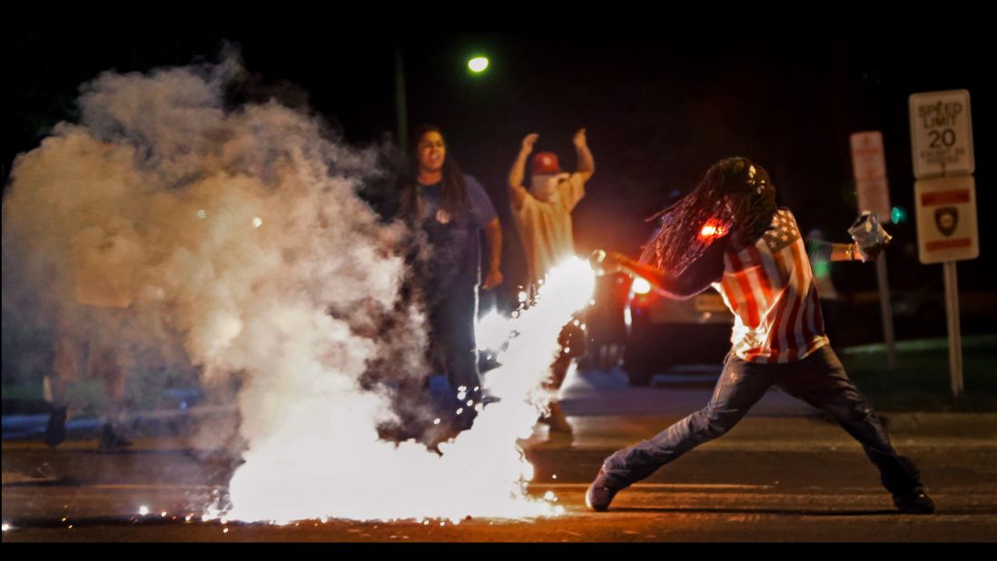 This is one of the most famous images from Ferguson, taken just four days after Brown's death. It captured a protester returning a tear gas canister fired by police who were trying to disperse the crowds.