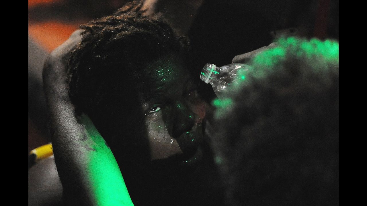 Scenes from Ferguson would at times show protesters treating their faces for exposure to elements like tear gas. This woman received assistance flushing out her eyes after being sprayed with mace when a peaceful protest escalated in August 2014. 