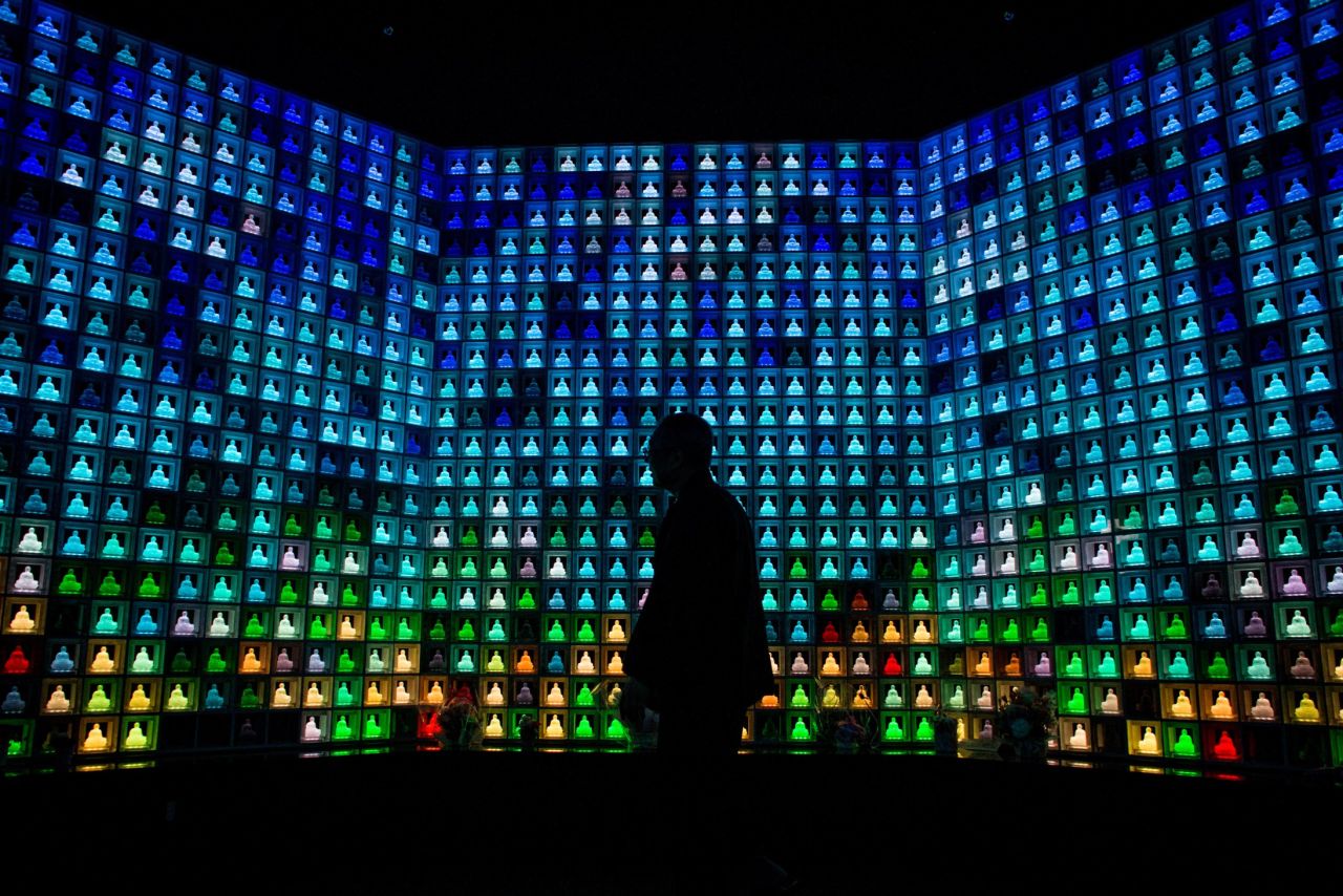 A Buddhist burial building in downtown Tokyo houses over 2,000 neon glass Buddha statues. Each statue corresponds to a drawer containing the cremated remains of the deceased. <br /><br />When a visitor enters the building they swipe an electronic pass card, which makes a single Buddha glow a different color, guiding the visitor to their loved one's statue.