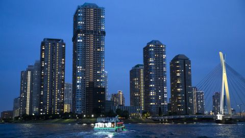 TOKYO, JAPAN - JUNE 10:  A yakatabune, or traditional low barge style boat, sails on the Sumida River as buildings stand illuminated at night on June 11, 2016 in Tokyo, Japan. About 35 companies operate over 100 yakatabune boats in Tokyo offering services such as dinner or karaoke inside the boats while cruising in Tokyo's bay area, according to the Tokyo Yakatabune Association.  (Photo by Tomohiro Ohsumi/Getty Images)