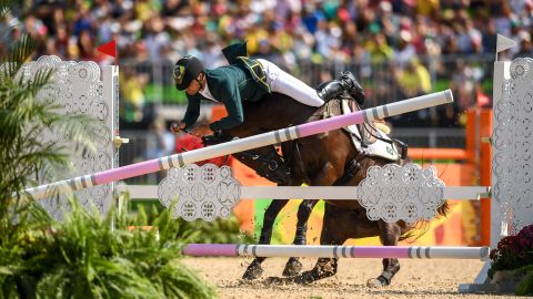 Brazilian rider Ruy Fonseca, on Tom Bombadill Too, hits an obstacle during the jumping round of the team eventing final.