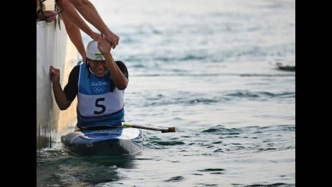 Japanese canoeist Takuya Haneda is congratulated after a ride in the C-1 slalom final. He won the bronze medal.