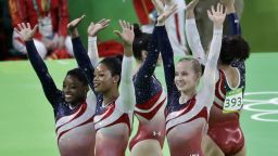 U.S. gymnasts, left to right, Simone Biles, Gabrielle Douglas, Aly Raisman, Madison Kocian, and Lauren Hernandez wave to the audience at the end of the artistic gymnastics women's team final.