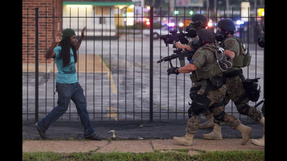 Heavily armed police confronted and eventually detained a man during protests two days after Brown's shooting. 