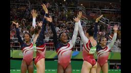 US gymnast Simone Biles (C) and her teammates celebrate after winning the women's team final Artistic Gymnastics at the Olympic Arena during the Rio 2016 Olympic Games in Rio de Janeiro on August 9, 2016. / AFP / Ben STANSALL        (Photo credit should read BEN STANSALL/AFP/Getty Images)