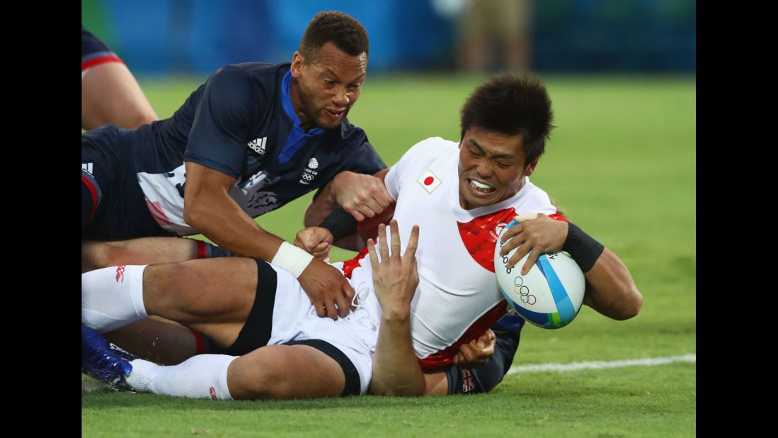 Japanese rugby player Katsuyuki Sakai scores a try against Great Britain.
