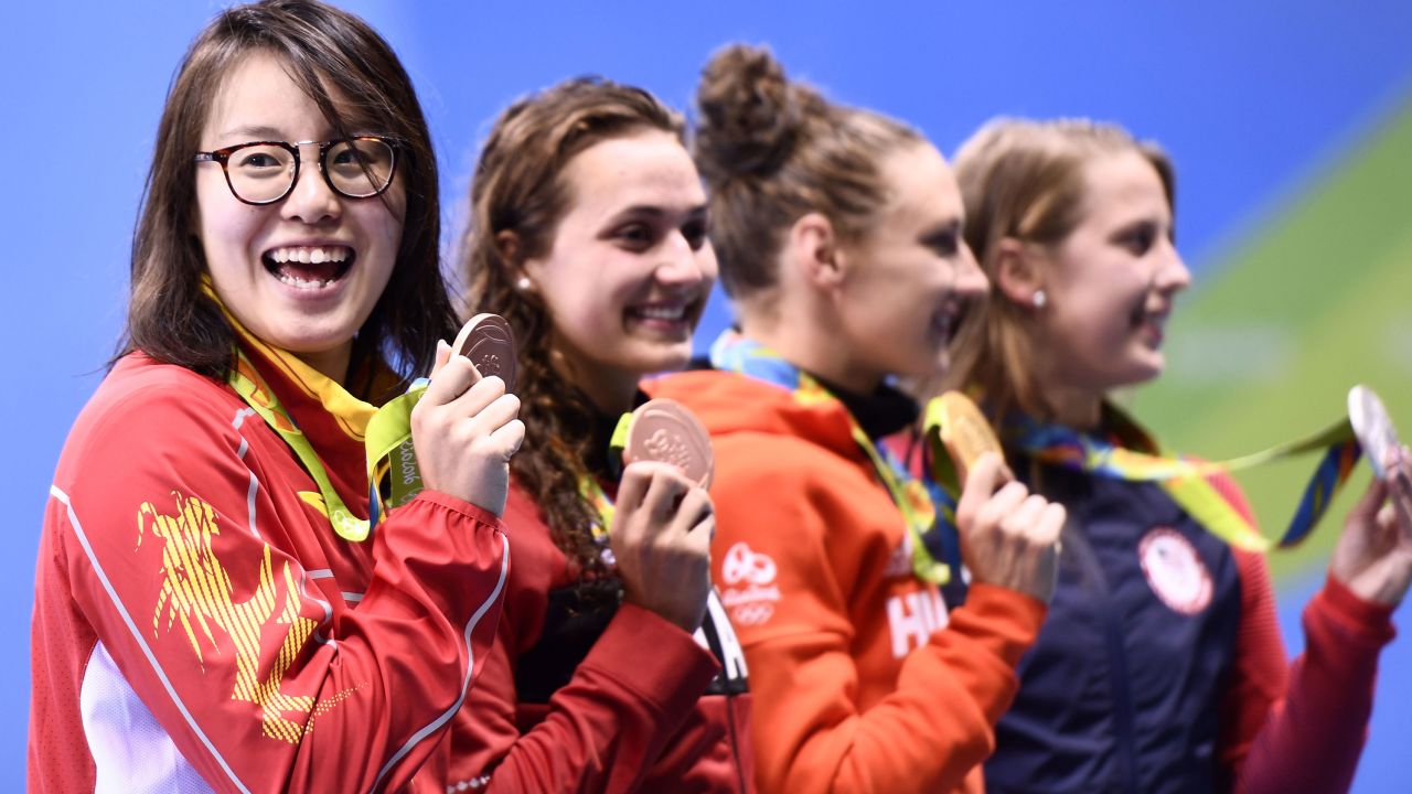 China's Fu Yuanhui on the medal podium. She charmed fans by eating a muffin during the live stream. 