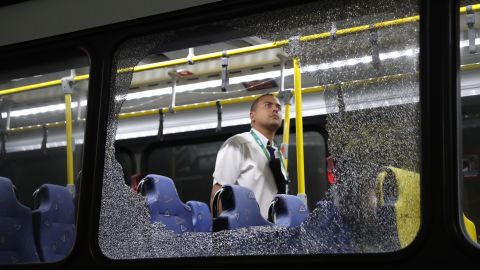 Two bus windows shattered after something struck the vehicle Tuesday as it transported journalists across Rio for the Olympics.