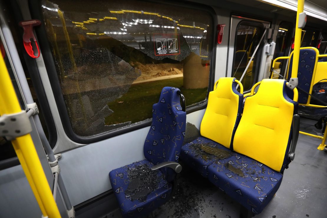 Shattered glass lies on the seats of a media bus in Rio de Janeiro.