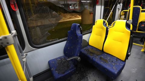 Shattered glass lies on the seats of a media bus in Rio de Janeiro.