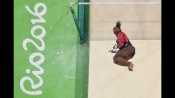 US gymnast Simone Biles competes in the qualifying for the women's Uneven Bars event of the Artistic Gymnastics at the Olympic Arena during the Rio 2016 Olympic Games in Rio de Janeiro on August 7, 2016.
