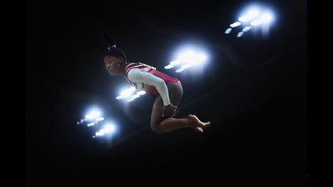 Her ability to jump high and maintain momentum in midair comes from a combination of her short stature and great strength. That's one reason why you'll see Biles perform so many "double-doubles." A double-double is a challenging double-twisting, double-back somersault tumbling move. You need to jump very high to have time to do all that twisting and flipping. Biles packs a lot of power into her 4 feet, 8 inches.