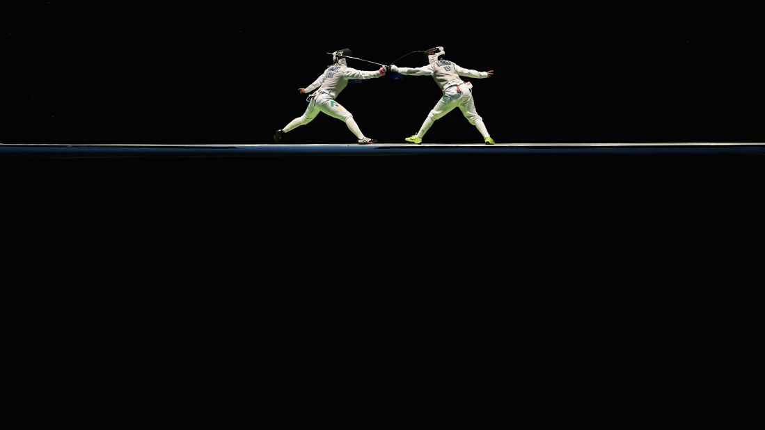 Brazilian fencer Tais Rochel, left, faces off against Saudi Arabia's Lubna Al-Omair during the women's individual foil competition.