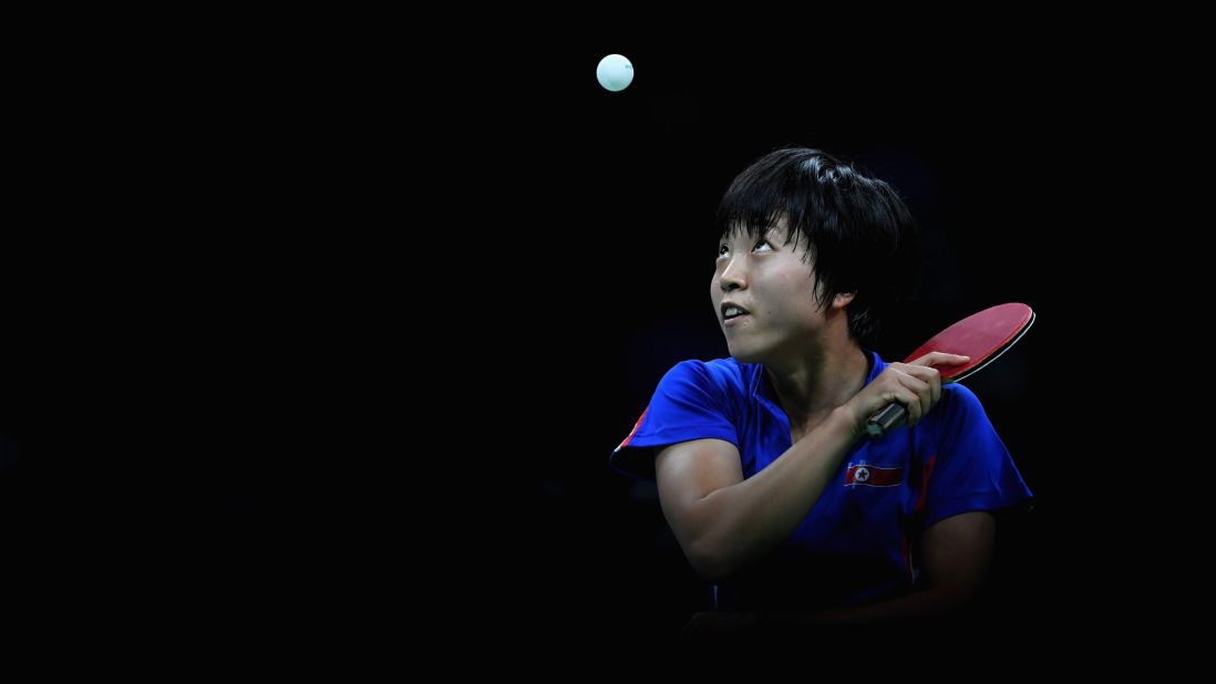 North Korean table tennis player Kim Song-i focuses on the ball during her semifinal match against Ding Ning of China. Ding advanced to the gold-medal match, which she won.