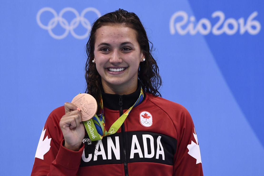 Canada's Kylie Masse poses with her bronze medal following the 100 meter backstroke event.
