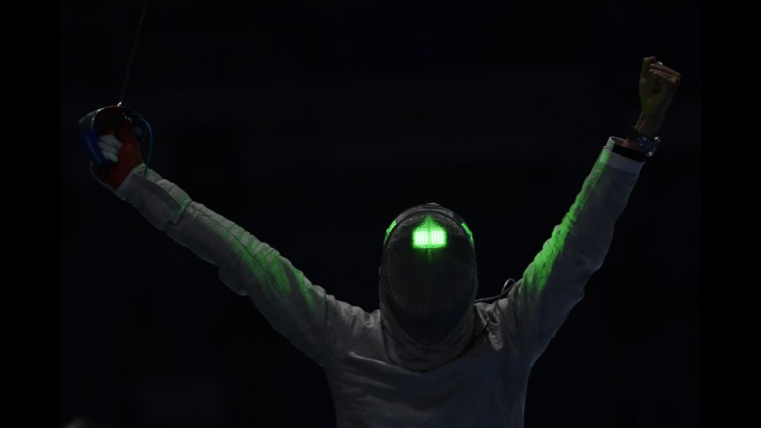 South Korean fencer Kim Jung-hwan celebrates after beating Georgia's Sandro Bazadze in the men's individual sabre competition. Kim finished with the bronze medal.