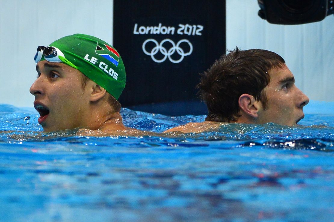 South Africa's Chad Le Clos (L) reacts after winning the men's 200m butterfly final next to second-placed US swimmer Michael Phelps (R) during the swimming event at the London 2012 Olympic Games on July 31, 2012 in London. AFP PHOTO / FABRICE COFFRINI (Photo credit should read FABRICE COFFRINI/AFP/GettyImages)