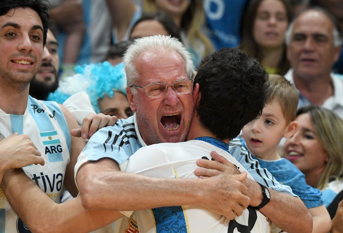  Argentinian volleyballer Demian Gonzalez is hugged by a fan after his team won the men's qualifying volleyball match between Russia and Argentina at the Maracanazinho stadium in Rio de Janeiro.