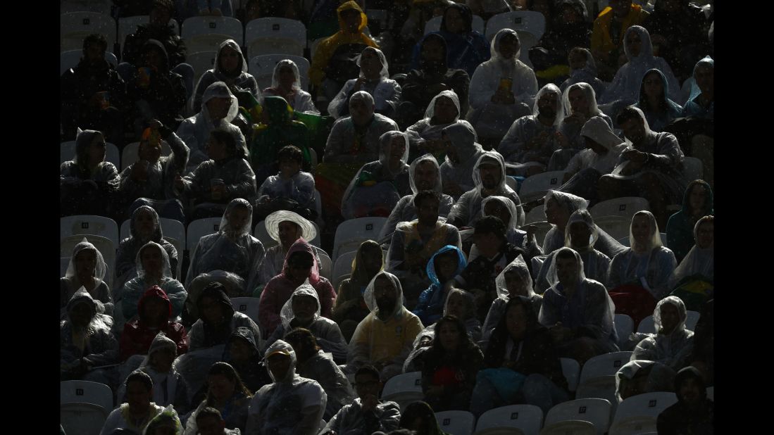 Fans watch a men's beach volleyball match.