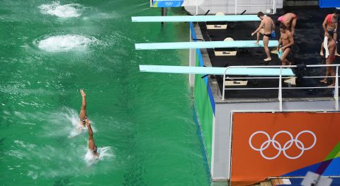 Synchronized divers practice for the 3-meter springboard event.