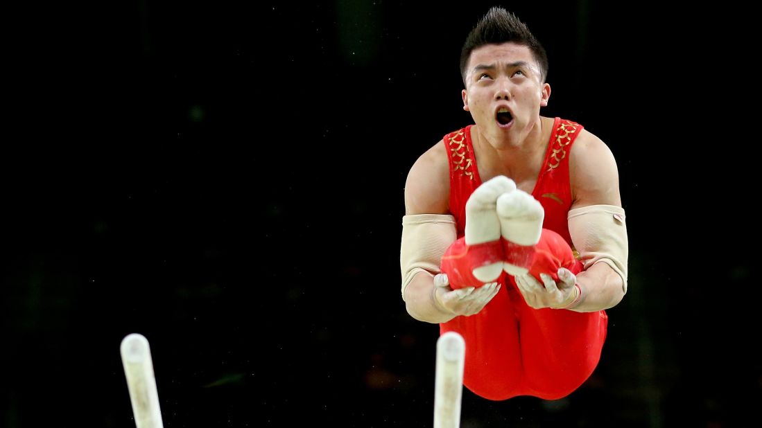 Chinese gymnast Chaopan Lin competes on the parallel bars during the individual all-around.