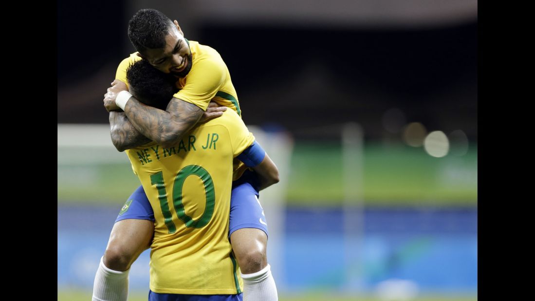 Gabriel Barbosa, top, hugs his Brazilian teammate Neymar after scoring the first goal in a 4-0 victory over Denmark. It was the first goal Brazil had scored in three matches.