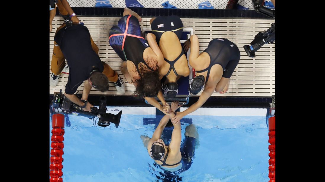 Katie Ledecky is congratulated by her U.S. teammates Allison Schmitt, Leah Smith and Emily DiRado after swimming the anchor leg of the 4x200 freestyle on Wednesday, August 10. The gold medal is Ledecky's third of the Rio Games.