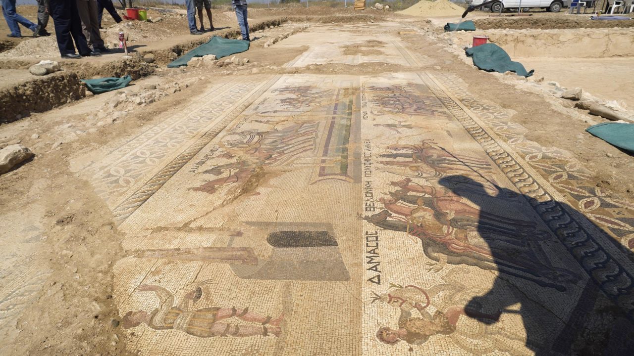 The shadow of Archeologist Fryni Hadjichristofi is cast over a rare mosaic floor dating to the 4th century depicting scenes from a chariot race in the hippodrome