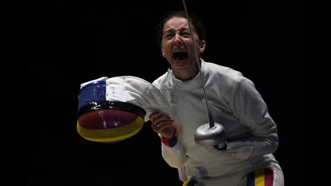 Romania's Ana Maria Popescu celebrates after her fencing team won an epee quarterfinal match against the United States.