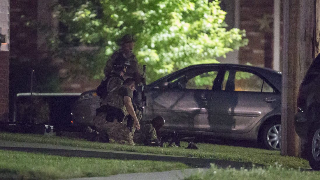 Police keep watch during the standoff Wednesday night. 