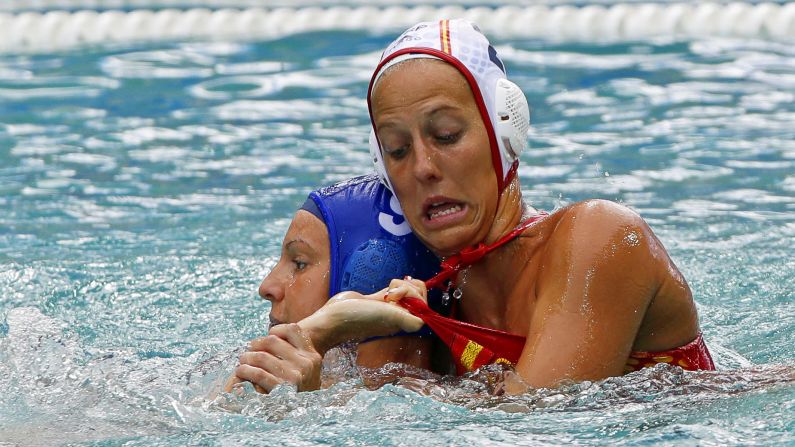 Hungary's Ildiko Toth, left, tussles with Spain's Marta Bach Pascual during a water polo game.
