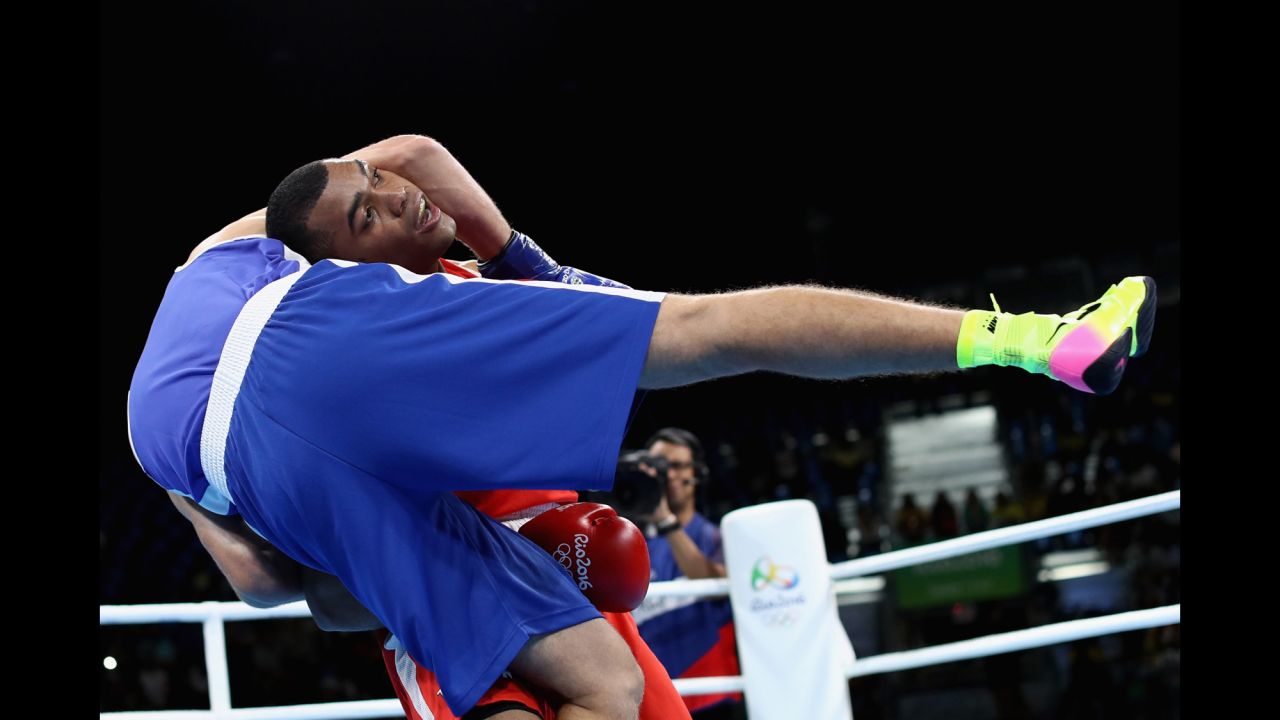 Venezuelan boxer Albert Ramirez, in red, faces Algeria's Abdelhafid Benchabla in a light-heavyweight bout. Benchabla advanced to the quarterfinals.