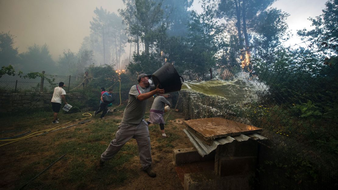 Residents work to fight a wildfire in As Neves in northwestern Spain on Thursday.