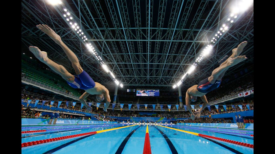 Phelps, left, and U.S. teammate Ryan Lochte jump into the pool for the 200-meter medley on Wednesday, August 10.