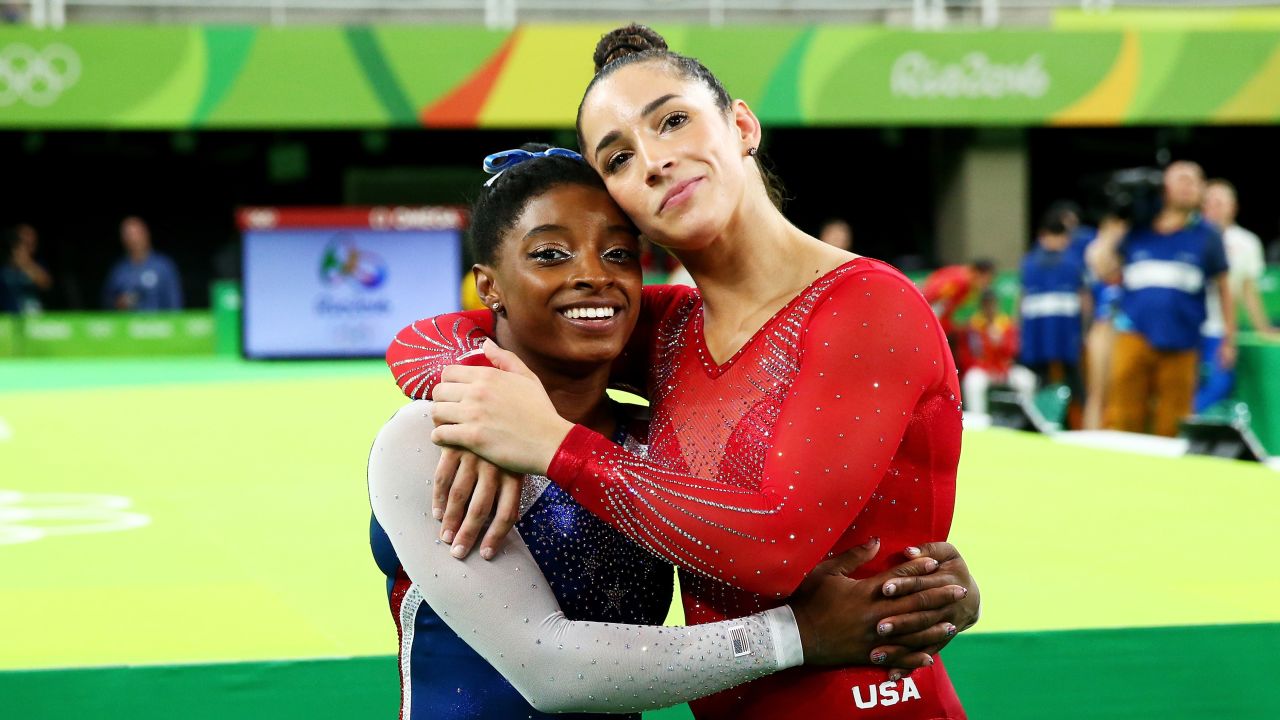 Biles hugs her teammate Aly Raisman, who won the silver.