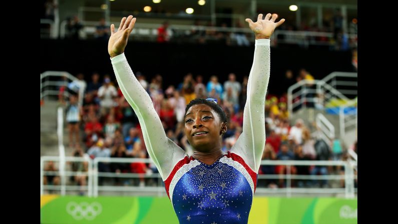 U.S. gymnast Simone Biles waves to fans after <a href="index.php?page=&url=http%3A%2F%2Fwww.cnn.com%2F2016%2F08%2F11%2Fsport%2Fsimone-biles-usa-gymnastics-rio%2Findex.html" target="_blank">winning gold in the individual all-around.</a> Biles also won team gold earlier this week.