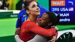 US gymnast Simone Biles (R) embraces US gymnast Alexandra Raisman at the women's individual all-around final of the Artistic Gymnastics at the Olympic Arena during the Rio 2016 Olympic Games in Rio de Janeiro on August 11, 2016. / AFP / Ben STANSALL        (Photo credit should read BEN STANSALL/AFP/Getty Images)