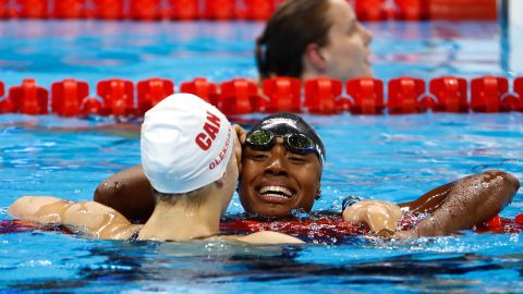Simone Manuel and Penny Oleksiak of Canada embraced after their dead heat.