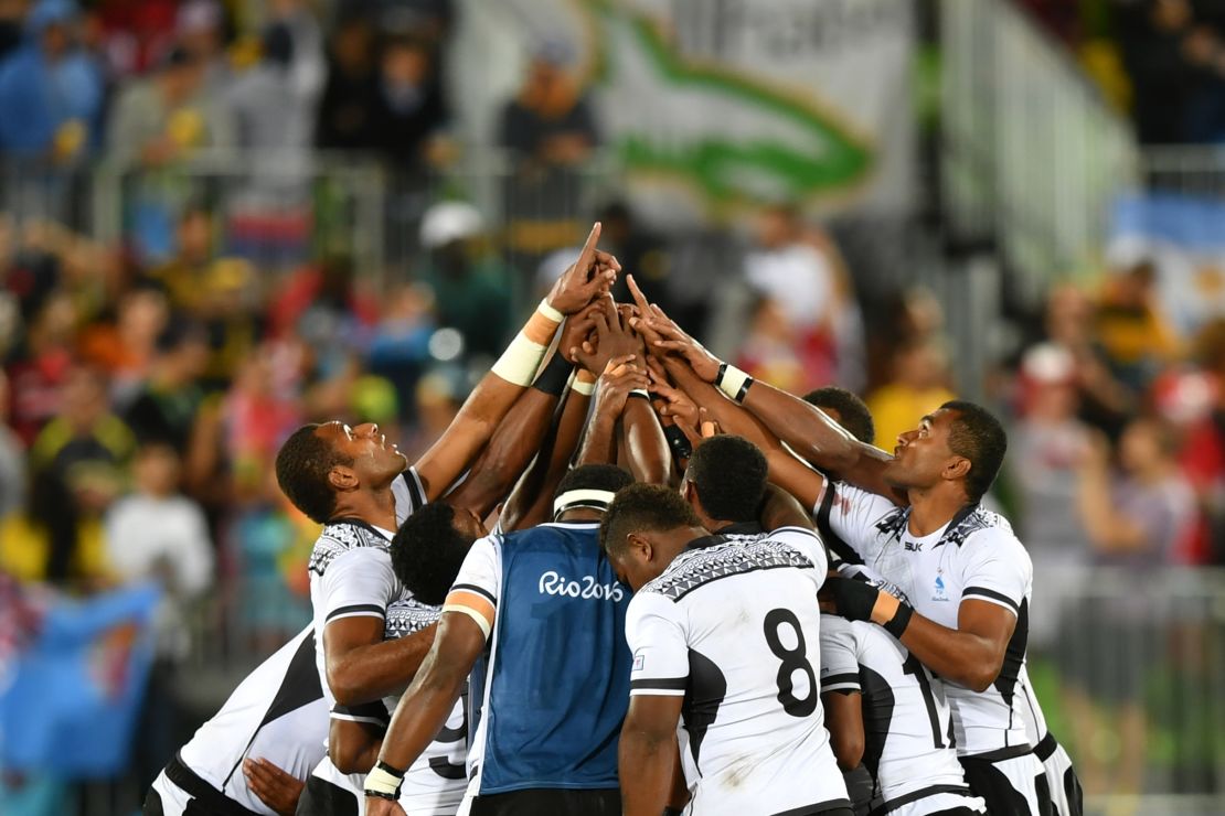 Fiji's players pray after victory in the men's rugby sevens gold medal match between Fiji and Britain during the Rio 2016 Olympic Games at Deodoro Stadium in Rio de Janeiro.