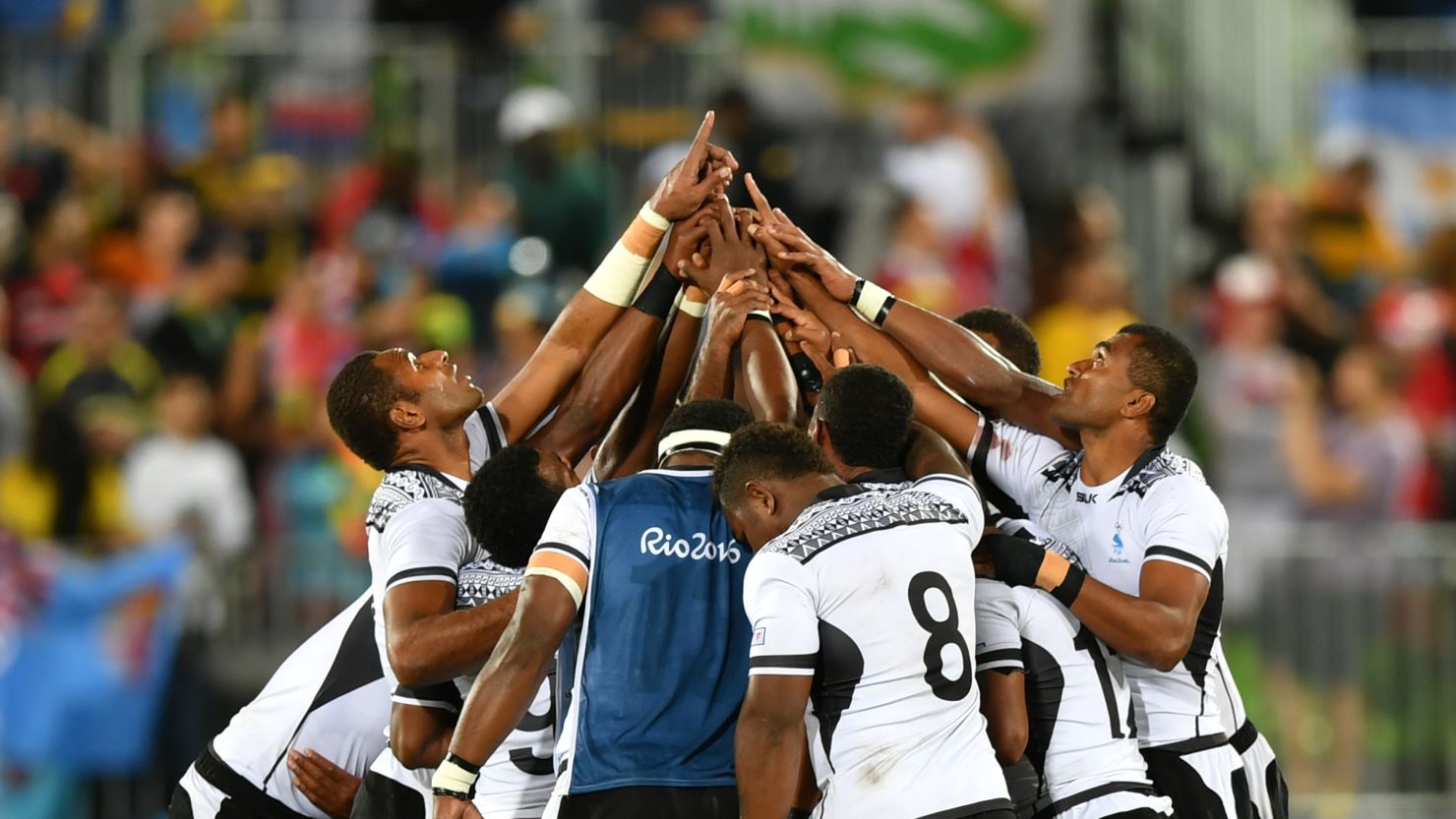 Fiji players give thanks after winning the men's rugby sevens final
