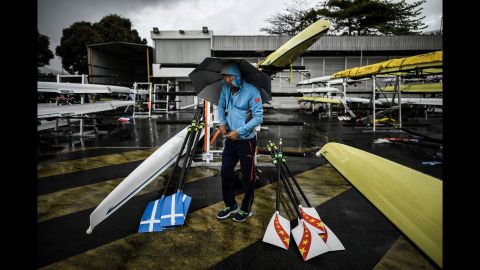 A rower prepares boats for a training session.